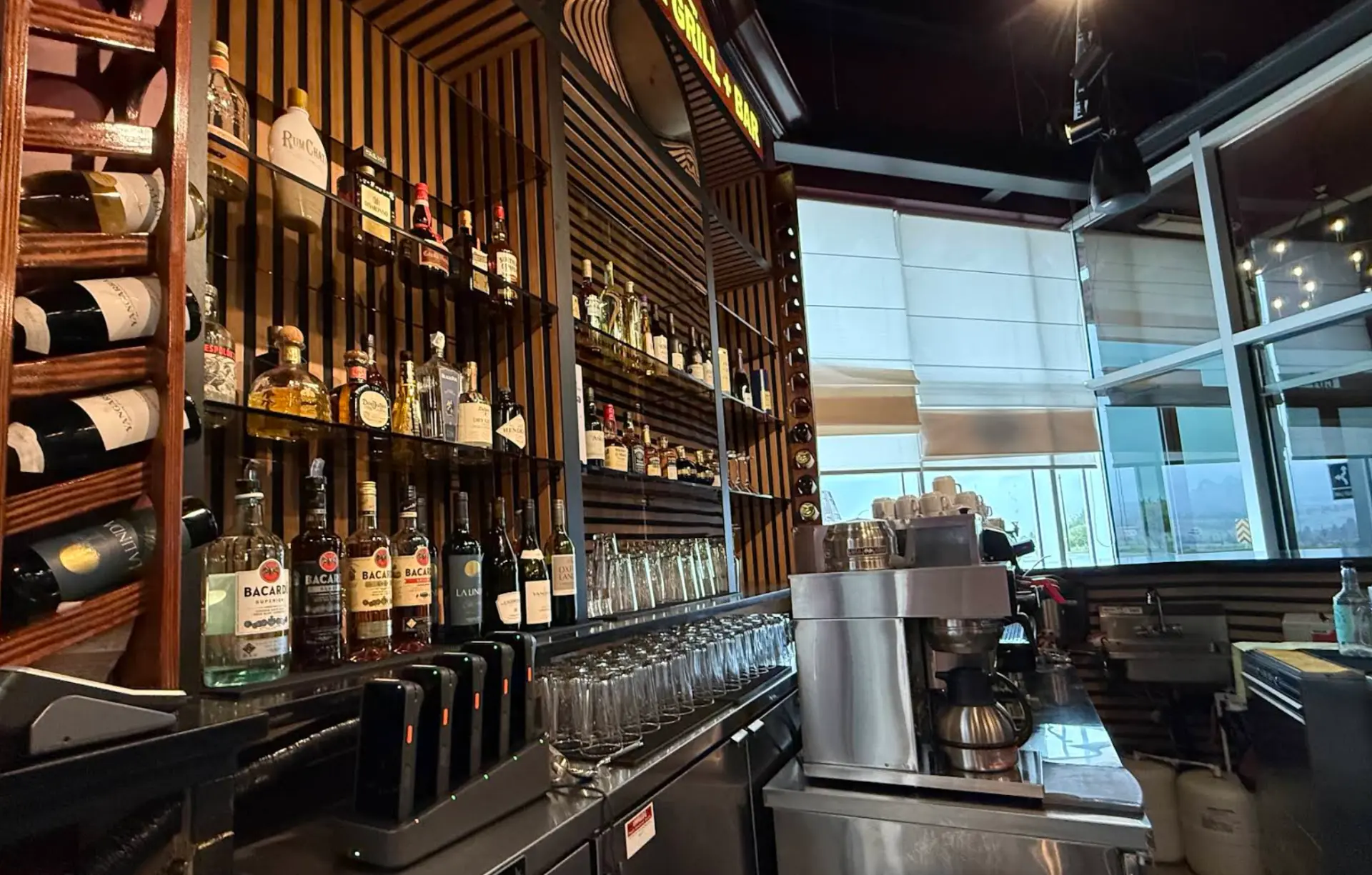 Back bar of wooden slats filled with liquor bottles